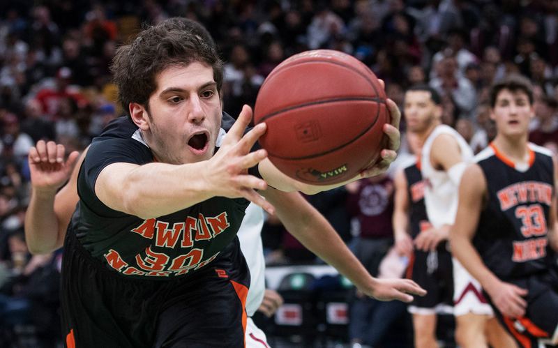 Basketball player in an orange 30 jersey driving to the hoop