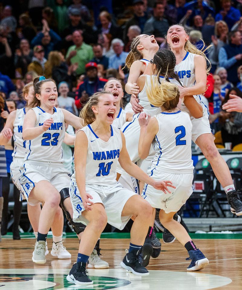 Girls basketball team celebrating a win